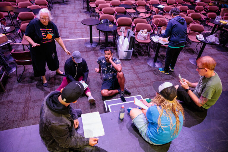 Theatrical performers acting live on stage.